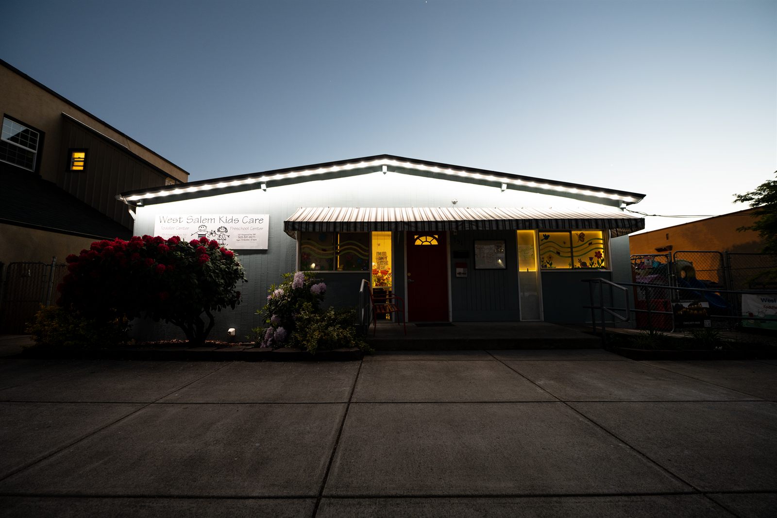 West Salem Kids Care with permanent LED roofline lights on at twilight